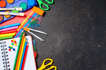 School supplies on dark table