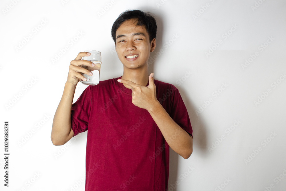 teenager pointing at his glass of water teenager pointing at his glass of water