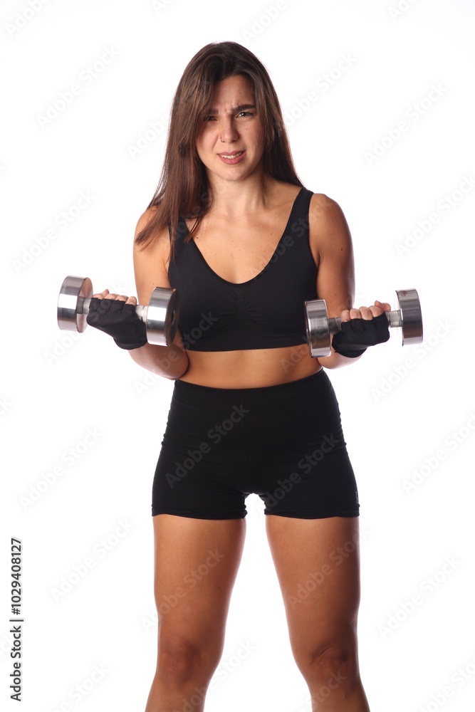 young confused woman with 2 dumbbells in front of white background young confused woman with 2 dumbbells in front of white background