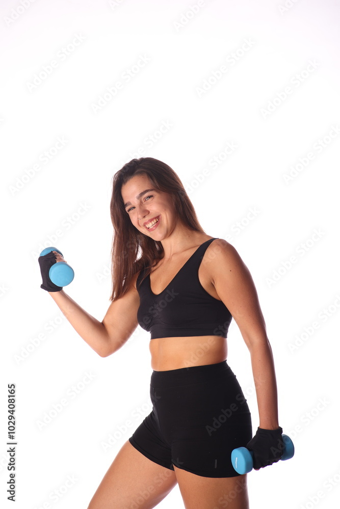 young smiling woman with 2 blue dumbbells in front of white background young smiling woman with 2 blue dumbbells in front of white background