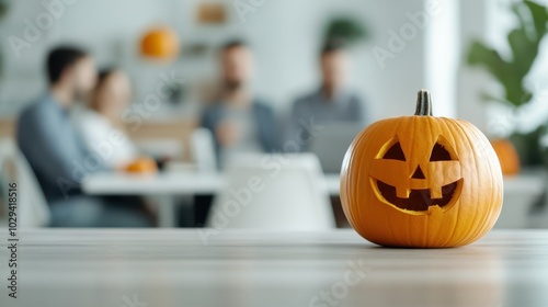 A festive Jack-o'-lantern with a carved smile sits prominently on a table in a modern office environment, bringing Halloween spirit into the workspace setting. photo