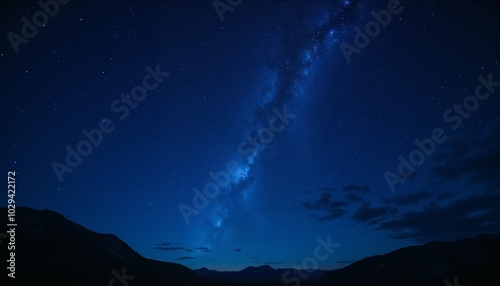 Starry night sky over mountains with the Milky Way visible, showcasing the beauty of the cosmos