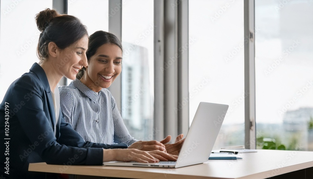 Two smiling professional business people talking using laptop computer working in office. Happy colleagues or entrepreneurs team man and woman discussing corporate technology at workplace Two smiling professional business people talking using laptop computer working in office. Happy colleagues or entrepreneurs team man and woman discussing corporate technology at workplace