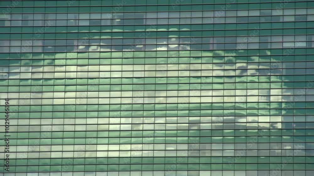 Reflection in a Skyscraper. Quickly running clouds reflected in the windows of a skyscraper. Time lapse Reflection in a Skyscraper. Quickly running clouds reflected in the windows of a skyscraper. Time lapse