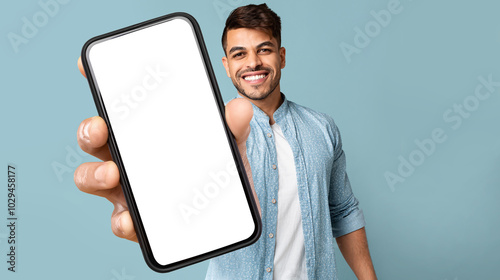 Smiling Handsome Arab Guy In Casual Showing Mobile Phone With White Blank Screen For Advertisement, Recommending Mobile Dating Application, Panorama With Free Space, Mockup, Colllage photo