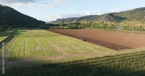 Tractor ploughing the land. Aerial view. photo