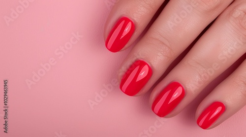 Deep red manicure on a female hand over a pink background, featuring glossy nails and offering copy space for beauty visuals, nail care marketing, or bold-themed branding concepts.


