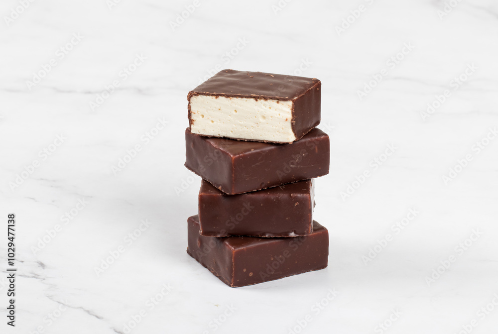 Bird's milk. Delicate dessert. Vanilla souffle in dark chocolate. Close up Bird's milk. Delicate dessert. Vanilla souffle in dark chocolate. Close up