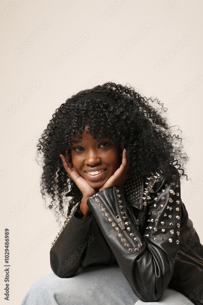 Close-up of smiling dark-skinned woman with afro hairstyle posing indoor. Mindset and mental health. Close-up of smiling dark-skinned woman with afro hairstyle posing indoor. Mindset and mental health.