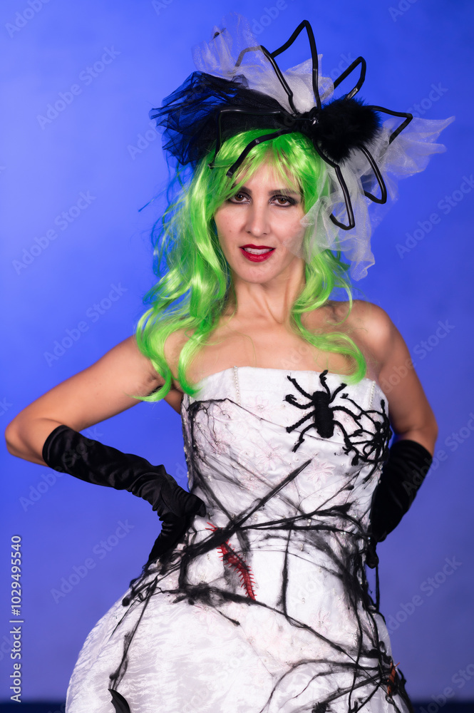 Girl in scary wedding dress with black web, green hair and head decorations. Scary Halloween bride costume. Halloween celebration. Dead bride costume Girl in scary wedding dress with black web, green hair and head decorations. Scary Halloween bride costume. Halloween celebration. Dead bride costume
