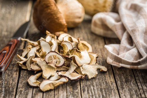 Fotografie Dried porcini mushrooms. Sliced boletus on wooden table.