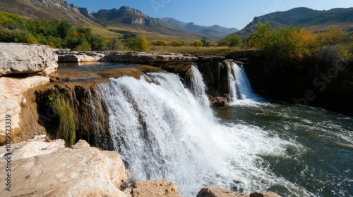 Scenic waterfall landscape in autumn with mountain backdrop for nature photography and travel inspiration