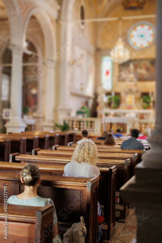 Slika na platnu Worshippers attend a religious service in a historic church during a serene Sund