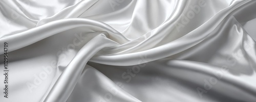 Elegant white satin fabric draped in soft folds creating a delicate texture in natural light at a textile workshop