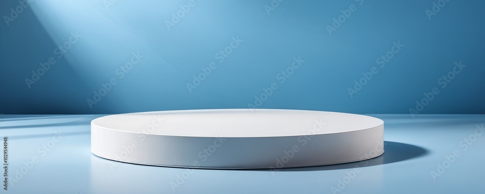 Minimalist circular pedestal on a blue background illuminated by soft light creating an elegant display space