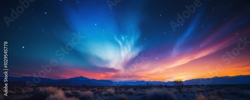 Vibrant twilight sky with colorful clouds and stars over a tranquil landscape at dusk in a remote desert location