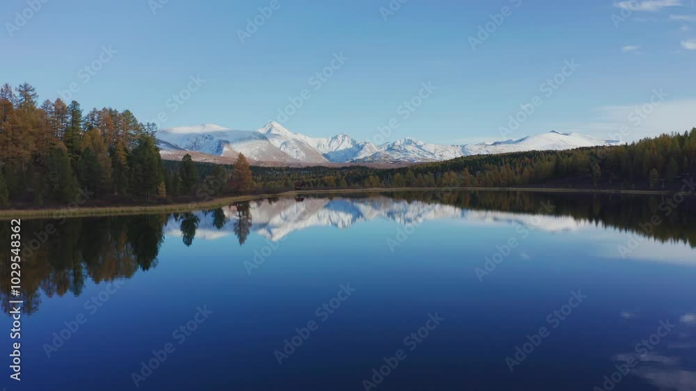 Breathtaking drone view of Mountain Altai in late autumn, capturing snow-capped peaks and clear lake reflections. The landscape reveals vibrant fall colors and serene natural beauty from above. Breathtaking drone view of Mountain Altai in late autumn, capturing snow-capped peaks and clear lake reflections. The landscape reveals vibrant fall colors and serene natural beauty from above.