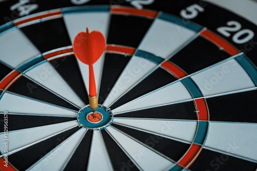 Concept of challenge in business marketing bullseye and intelligent customer reaching. The dart is the strategy or skill. The dartboard is the target or goal. uds photo