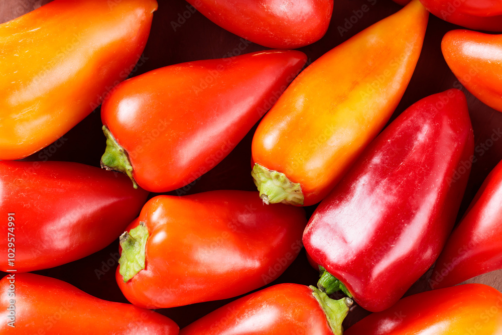 Vibrant Red and Orange Bell Peppers on Brown Background, Close-Up Vibrant Red and Orange Bell Peppers on Brown Background, Close-Up