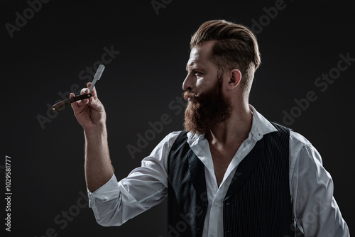 Man with red beard. Hairstylist at barber shop isolated on black. Barber using retro blade. Brutal hairdresser cutting hair. Hairstylist serving at barber shop. Barbershop. Fresh shave