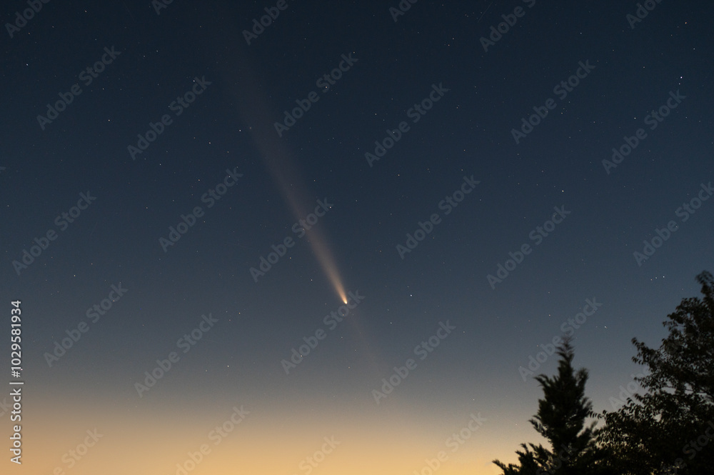 Naklejka premium stars and comet in evening sky, magical shot of space after sunset