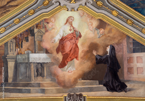 фотографія VOGHERA, ITALY - SEPTEMBER 12, 2024: The ceiling fresco of Apparition of  Divine Mercy of Jesus to Faustina Kowalska from side nave of Domo - Collegiata di San Lorenzo by Luigi Morgari (1906 - 1908)