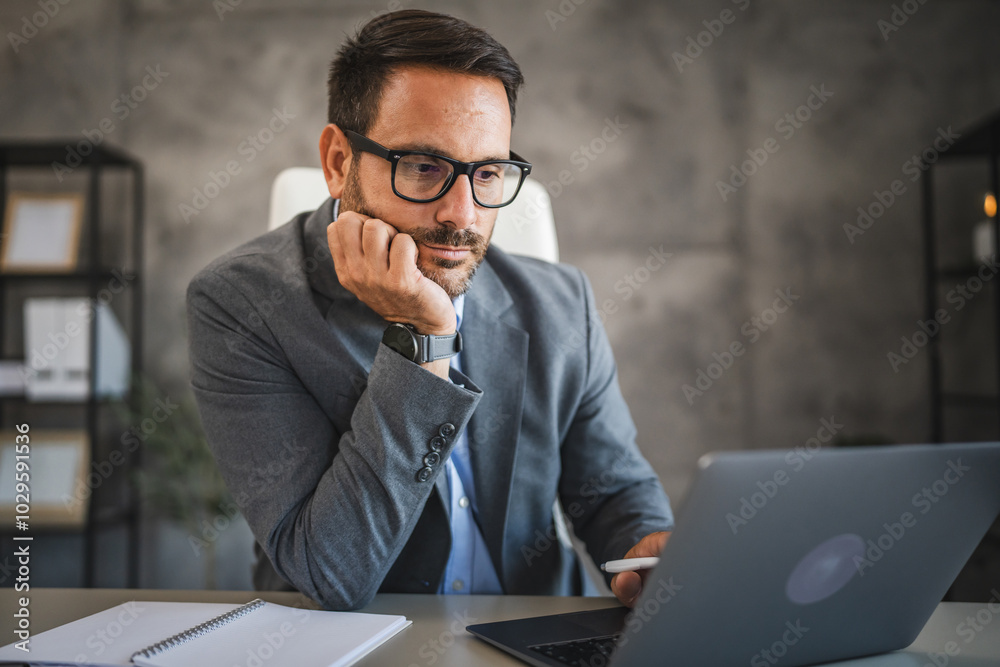 confident businessman work on new project on laptop in modern office confident businessman work on new project on laptop in modern office
