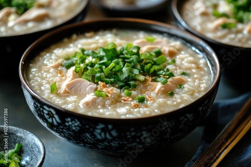 A close-up of a bowl of chicken congee. This photo is perfect for showcasing the flavors of Asian cuisine, especially for websites or blogs about food and cooking.