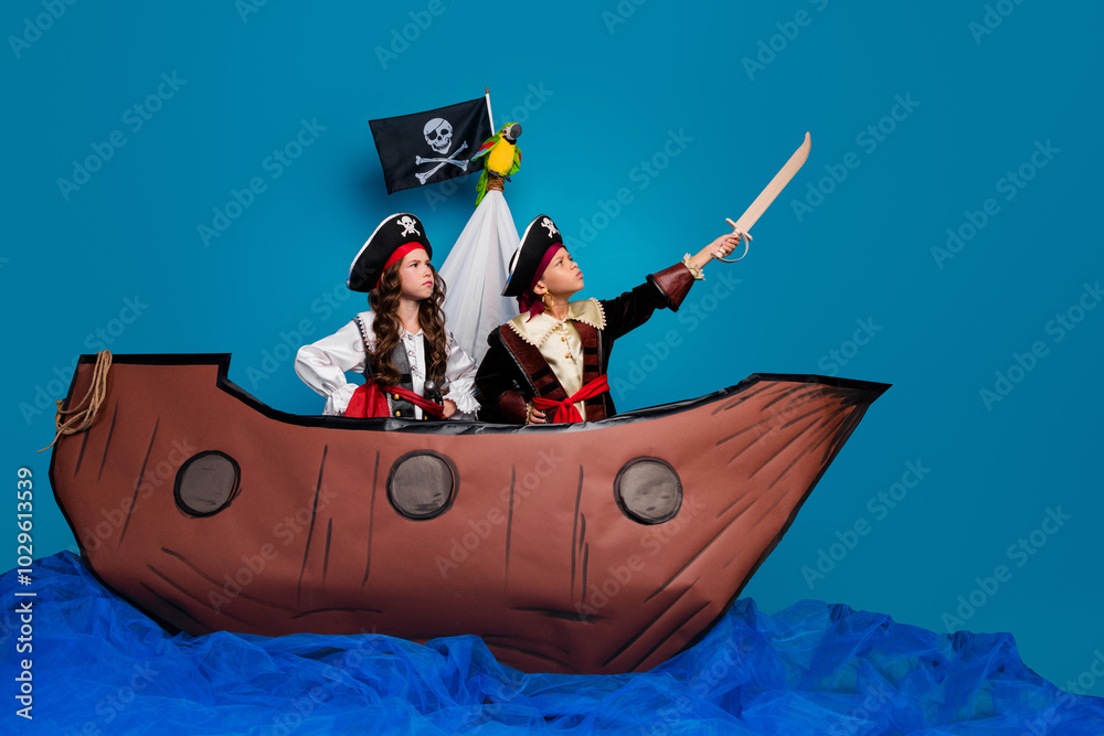 Full body photo of cute little boy girl brave raise saber dressed pirates costumes float ship decor isolated on blue color background