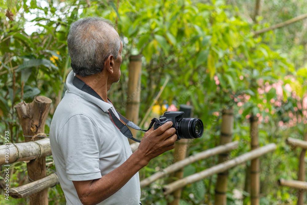 Senior nature photographer on mountain - professional photographer taking photos of nature in the forest Senior nature photographer on mountain - professional photographer taking photos of nature in the forest