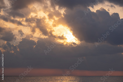 Sunlight filtering through the clouds over the sea