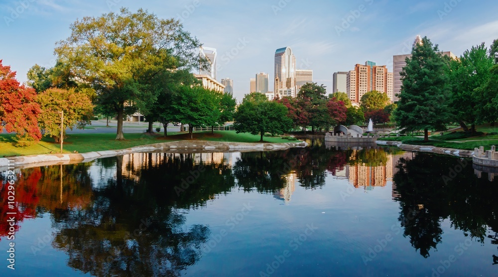 Pond in Marshall Park and downtown city skyline of skyscrapers at sunrise. Charlotte, North Carolina, United States. Pond in Marshall Park and downtown city skyline of skyscrapers at sunrise. Charlotte, North Carolina, United States.