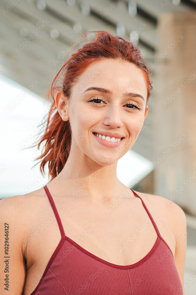 Vertical individual portrait of one redhead female smiling and looking at camera outside. Young adult woman with friendly expression staring front. Face of one real girl laughing. Optimistic lady Vertical individual portrait of one redhead female smiling and looking at camera outside. Young adult woman with friendly expression staring front. Face of one real girl laughing. Optimistic lady