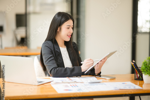 Asian business woman working and talking at the office 