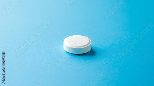 circular medicine pill rests on a blank background, symbolizing simplicity, health, medical care, treatment, and the precision of pharmaceutical science