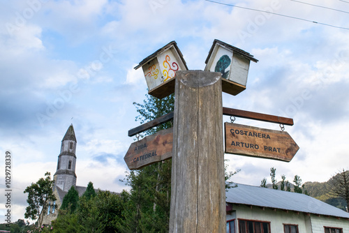 Fotografie Weathered wooden direction sign indicating the direction of the cathedral and th
