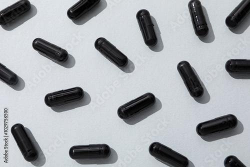 Activated carbon in the form of tablets, on a light background.