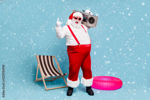 Full length body size view of his he nice naughty glad cheerful cheery fat Santa dj carrying retro tape player showing horn sign isolated over blue turquoise pastel color background