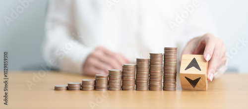 wood block of Arrow  change to UP and Down with money coins stack. Interest rate, GDP, stocks market, financial, deflation and Inflation, ranking, mortgage, debt, Loan and Economic Recession