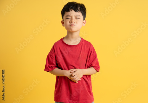 image of asian boy posing on yellow background