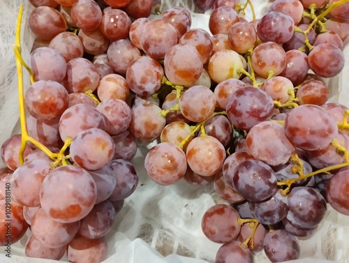 Various kinds of fresh fruit on display in the supermarket   photo