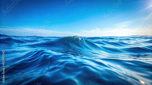 Soothing blue ocean waves on a minimalist abstract studio background low angle