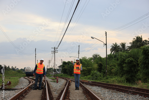 Senior male and female railway engineers are inspecting the railroad tracks for maintenance and improvements to ensure safe transportation of goods.