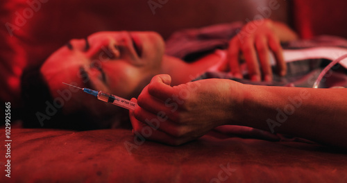 Foto Drugs, overdose and man on couch with syringe, health risk and narcotic danger in apartment at night