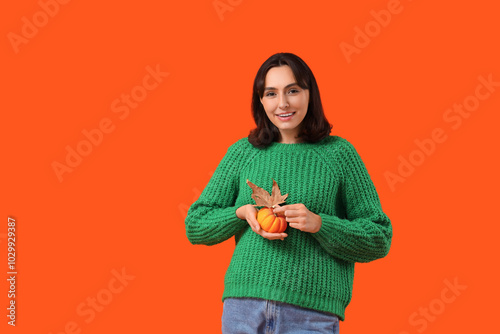 Young woman with pumpkin an...