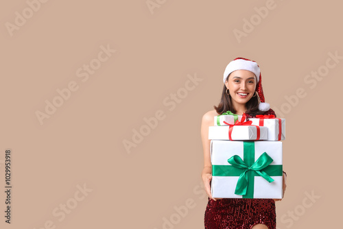 Young woman in Santa hat wi...