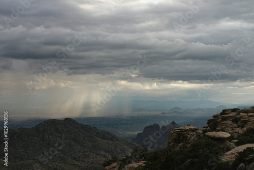 Dramatic sky raining on distant valley photo