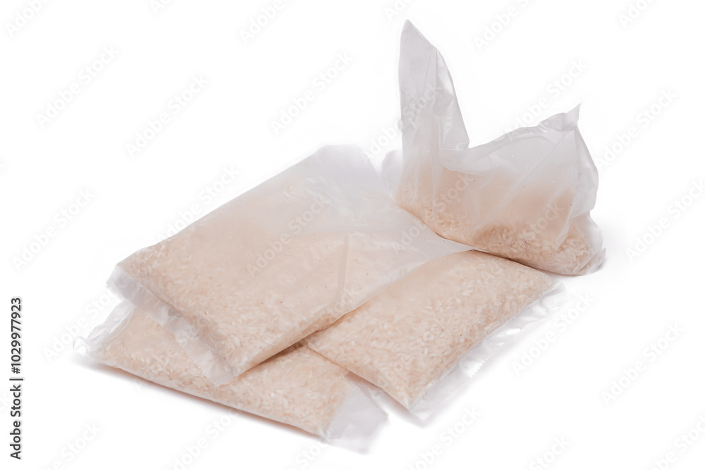 Obraz premium A Plastic Bags of White Long Grain Rice - Isolated on White Background. Small Transparent Packages with Dry Rice - Isolation