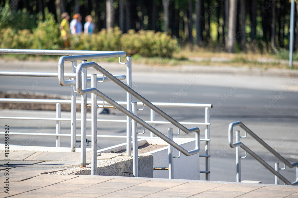 A metal railing with a staircase leading up to it A metal railing with a staircase leading up to it