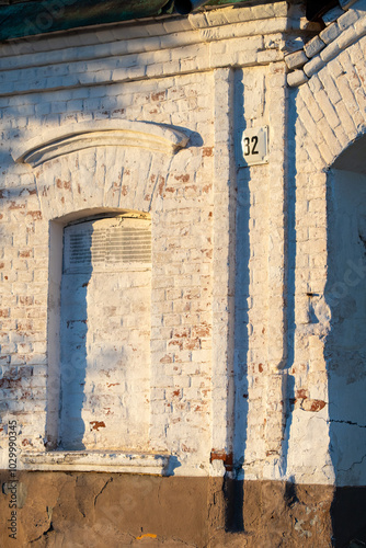 A brick building with a window and a number 22 on the side photo